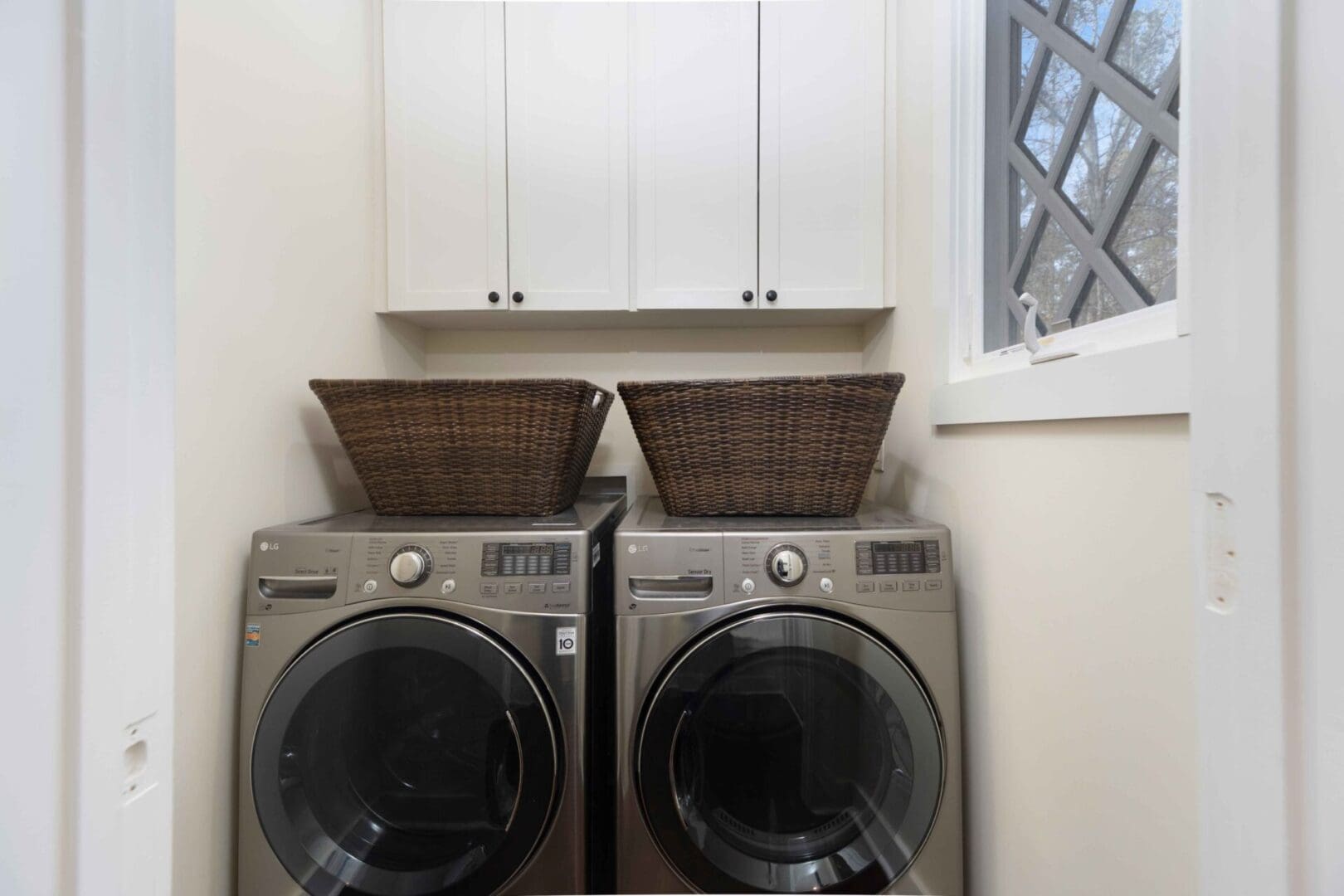A pair of washing machines in a laundry room.